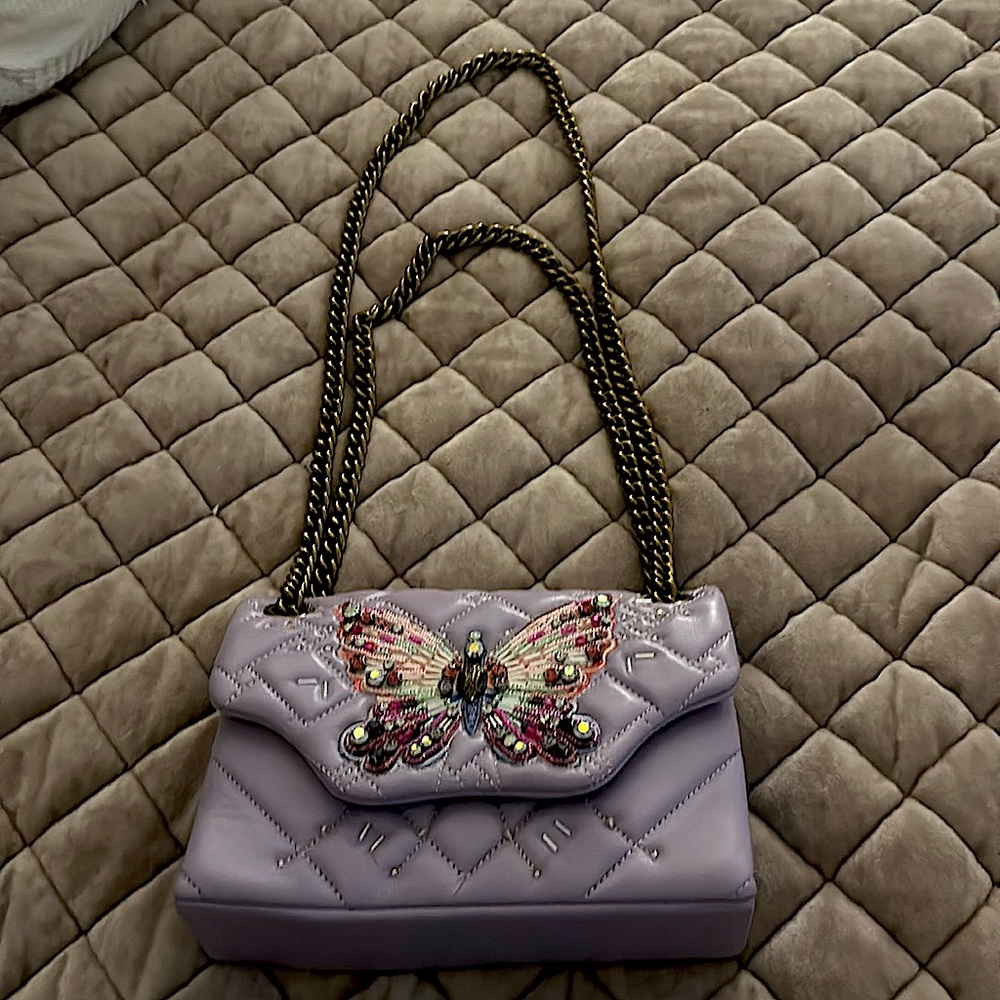 This is a butterfly hand bag, made by Kurt Geiger.